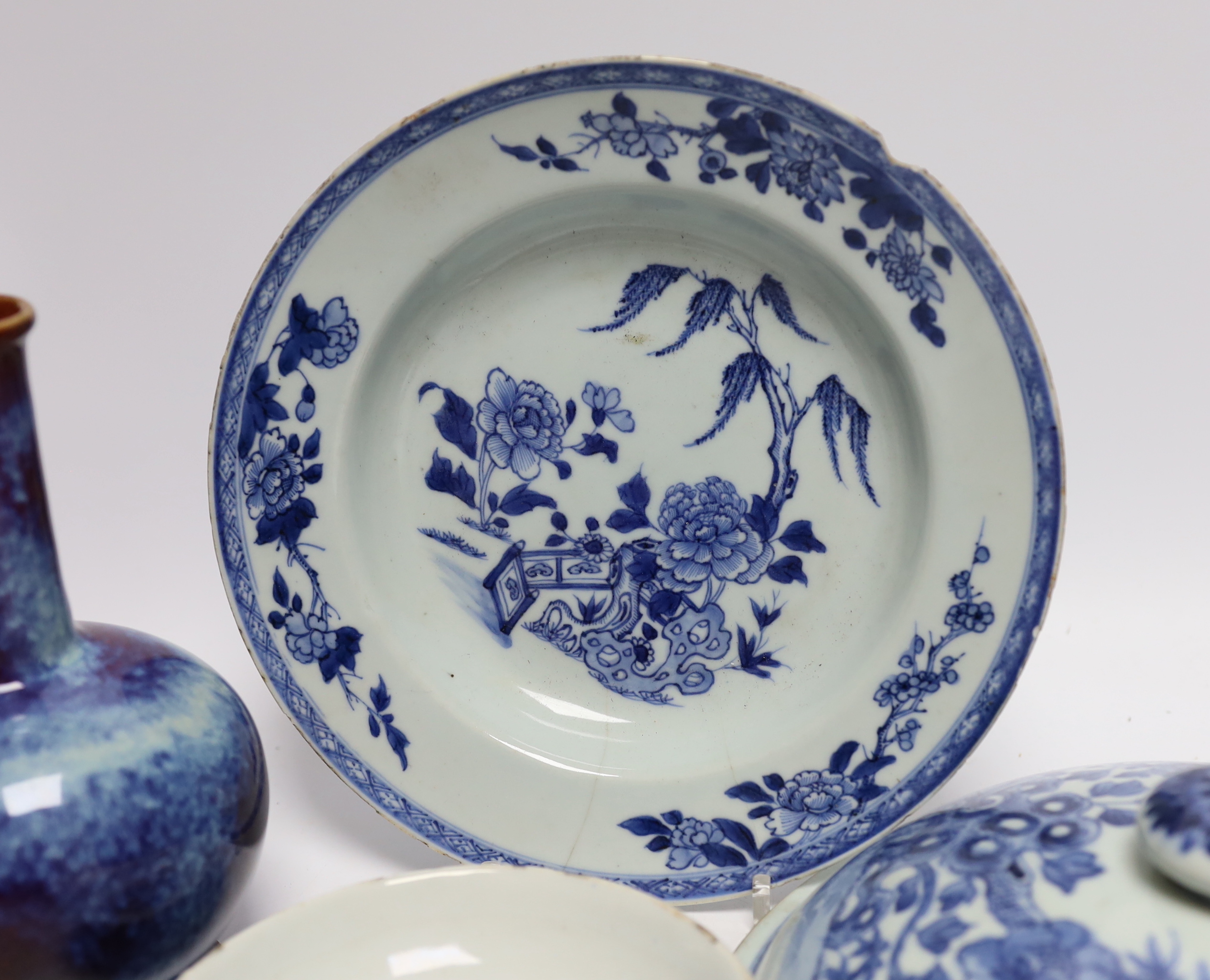 A group of Chinese ceramics including a flambé vase, an 18th century blue and white floral plate and a similar lid, 25cm diameter